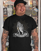 in masa we trust praying hands with masa ball on a black shirt from taco gear on hispanic male model