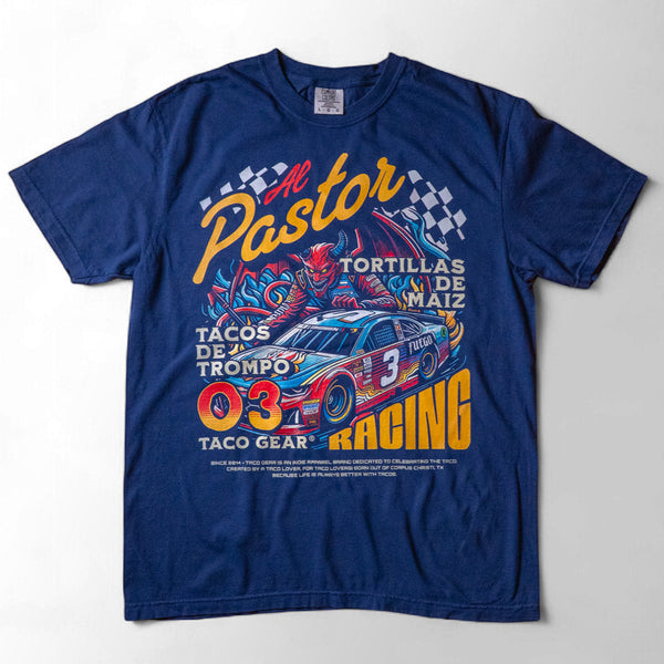 Taco Gear Al Pastor Racing t-shirt with colorful taco-themed racecar graphic, devil driver, and bold “Tacos de Trompo” and “Racing” text on navy and red tees.