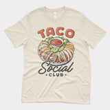 a natural cream vintage looking shirt with a large plate of street tacos on it with the words "Taco Social Club" around it
