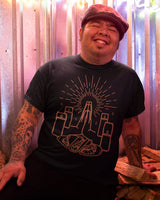 taco gear praying hands bless these tacos shirt in black with full gold design on smiling hispanic model
